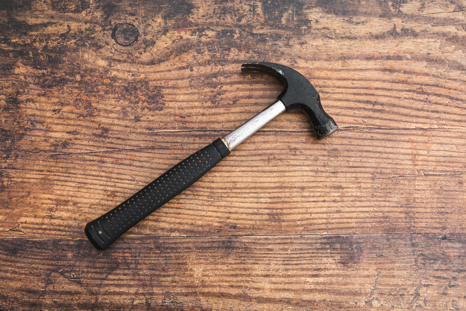 A carpenter's hammer resting on a timber workbench