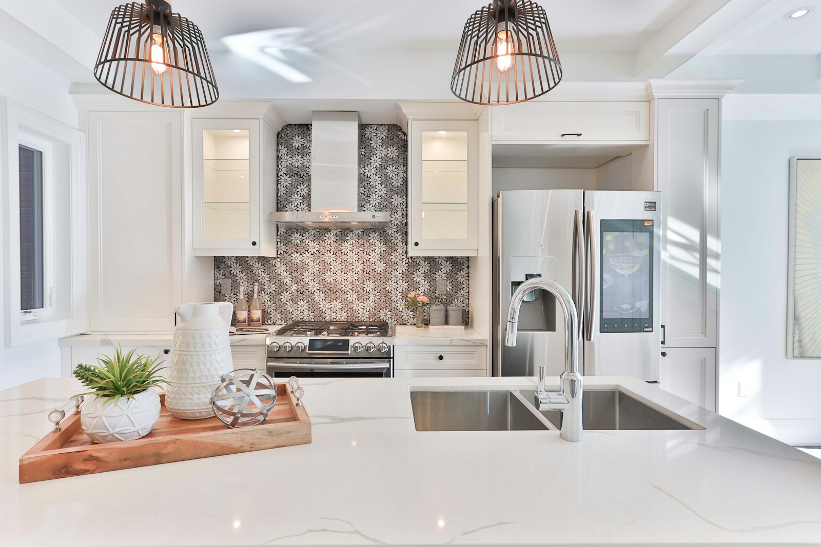 Renovated kitchen with stone benchtops and pendant lighting