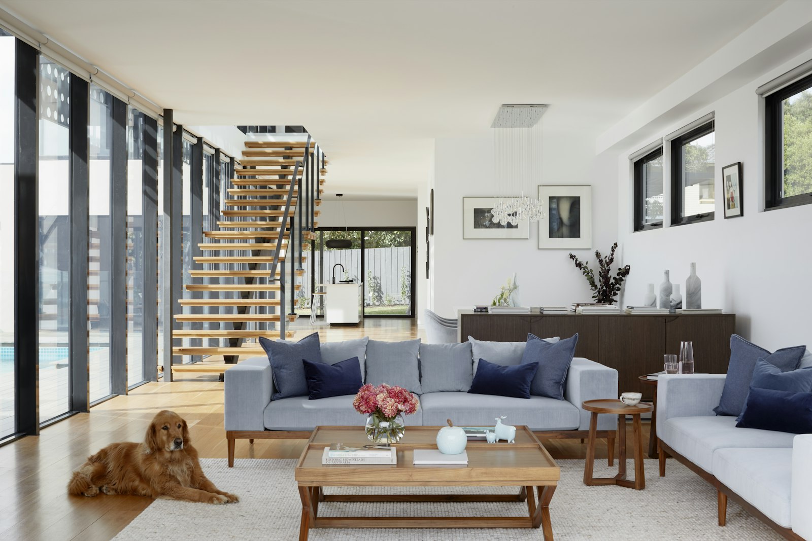 Open living area with a timber floating staircase